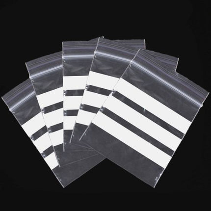 Clear plastic bags with black sealing strips on a black background