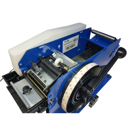 Close-up of a blue label printer on a white background