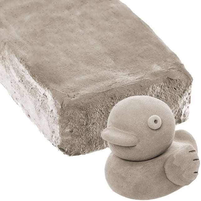 Concrete block with a concrete duck figurine on a white background