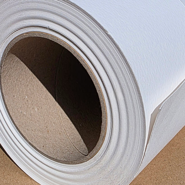 Close-up of a roll of white paper with brown cardboard core